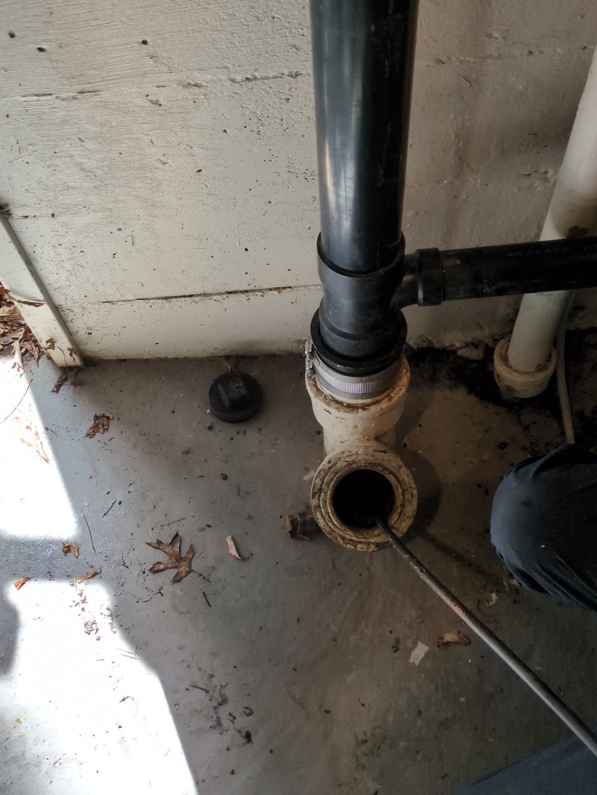 Exterior cleanout opened at the side of a Ballard house with the jetter hose fed down into the side sewer