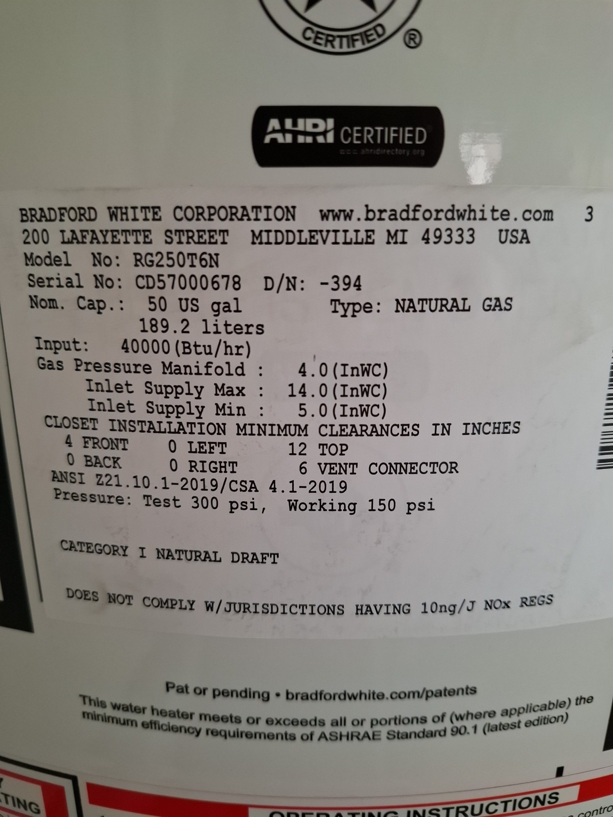 Manufacturer data plate on the new water heater showing the model, 50-gallon capacity and 40,000 BTU natural gas rating